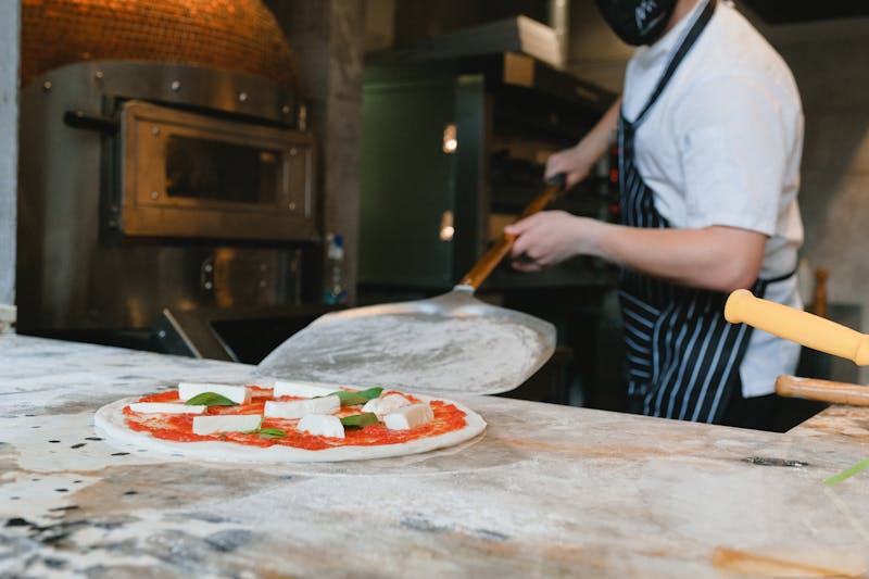 Seasons Pizza team preparing fresh pizza with seasonal ingredients